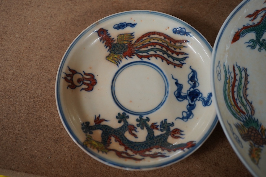 A pair of Chinese pedestal cups and three saucers. Condition - one cup severely damaged